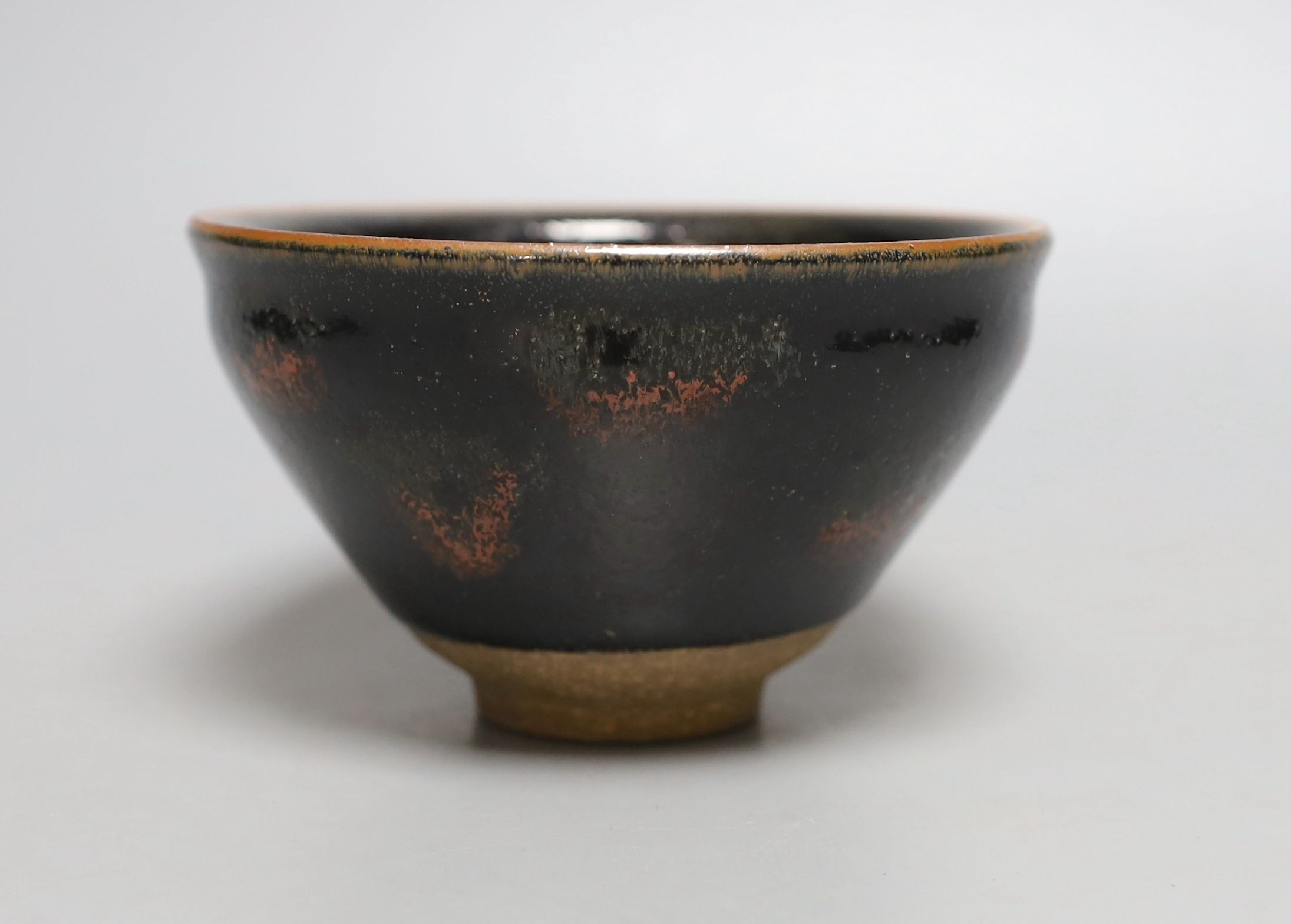 A Chinese black and red pottery bowl - 7.5cm tall